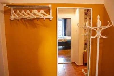 a hallway with a bunch of shoes on a rack at Triple King Size Balcony Suite in Prague
