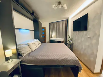 a bedroom with a bed and a television in it at Cozy Apt Near Prague Castle in Prague