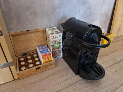 a coffee maker sitting next to a box of chocolates at Cozy Apt Near Prague Castle in Prague