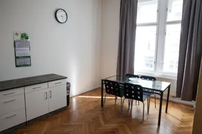 a dining room with a glass table and chairs at 2B Pechackova family apartment with balcony by the river in Prague