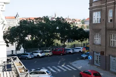 a group of cars parked in a parking lot at 2B Pechackova family apartment with balcony by the river in Prague