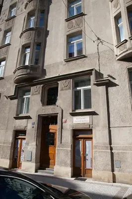 a building with doors and windows on a street at 2B Pechackova family apartment with balcony by the river in Prague