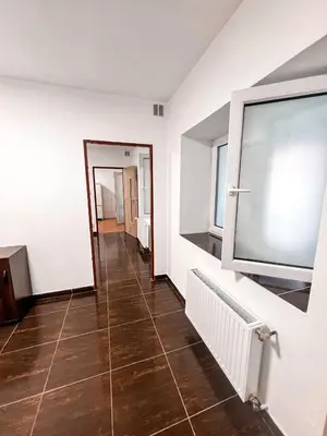 a hallway with white walls and a tile floor at 3 Apartments in 1 location in Prague