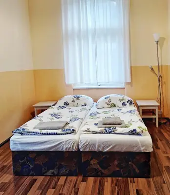 a small bed in a room with a window at Apartmán Nad hradem in Týnec nad Sázavou