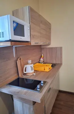 a small kitchen with a microwave and a sink at Apartmán Nad hradem in Týnec nad Sázavou