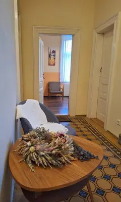 a room with a table with a flower arrangement on it at Apartmán Nad hradem in Týnec nad Sázavou