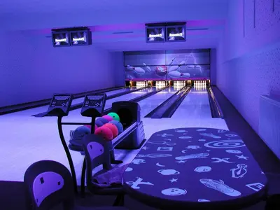 a bowling alley with pins and balls on the lanes at Sporthotel Hostivice in Hostivice