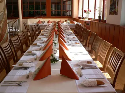 a long long table in a room with chairs at Sporthotel Hostivice in Hostivice