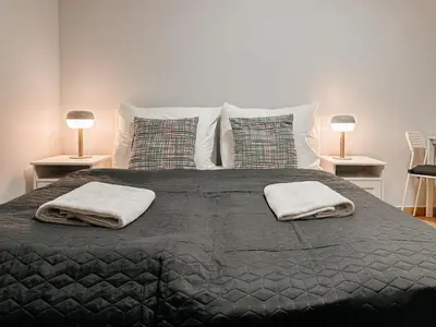 a bedroom with a bed with two towels on it at ELSO apartments in Prague
