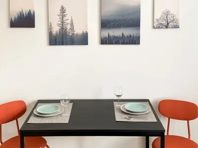 a dining room with a black table and four chairs at ELSO apartments in Prague