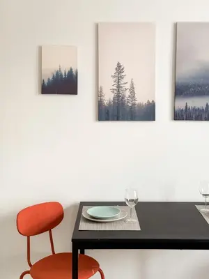 a dining room with a table and a red chair at ELSO apartments in Prague