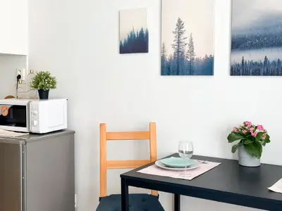 a kitchen with a table and a microwave on a counter at ELSO apartments in Prague