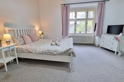 a bedroom with a bed with a teddy bear on it at Finnem Rentals Kyjevská in Prague