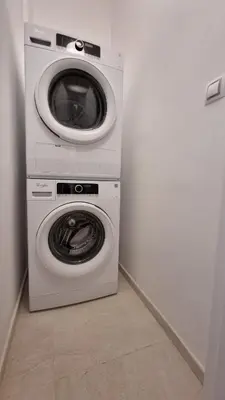 a washing machine and a dryer in a room at Finnem Rentals Průběžná in Prague