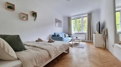a bedroom with a bed and a couch in a room at Finnem Rentals Průběžná in Prague