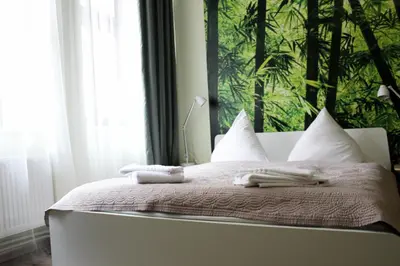 a bedroom with a bed with towels on it at Ruterra Apartment Cimburkova in Prague