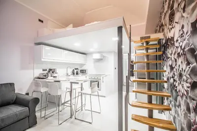a small apartment with a kitchen and a living room at Ruterra Apartment Cimburkova in Prague