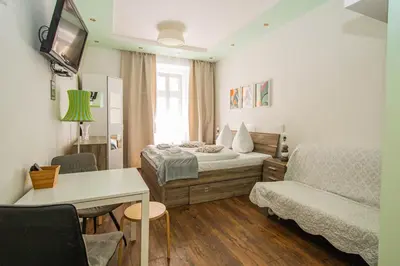 a small room with a bed and a couch at Ruterra Apartment Cimburkova in Prague