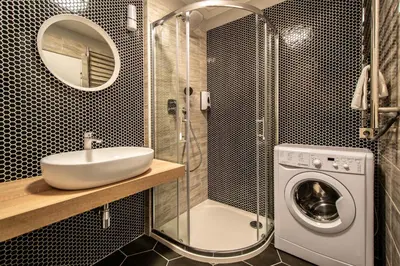 a bathroom with a sink and a washing machine at Ruterra Apartment Cimburkova in Prague