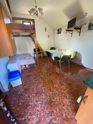 a living room with a floor covered in red marble at Apartmánová chata Martina in Hradištko