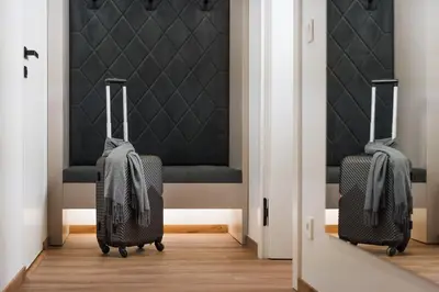 two pieces of luggage walking out of a door at NOBILIS RESIDENCE in Prague