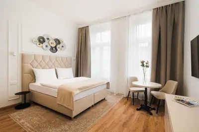 a hotel room with a bed and a table at NOBILIS RESIDENCE in Prague