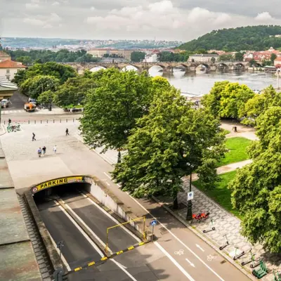 a tunnel in a city with a river and a bridge at Beautiful & peaceful apartment with cute balcony in Prague