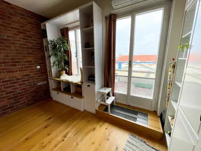 a room with a brick wall and a window at Vantisch Studio in Prague