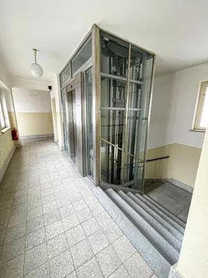 an empty hallway with glass doors in a building at Vantisch Studio in Prague