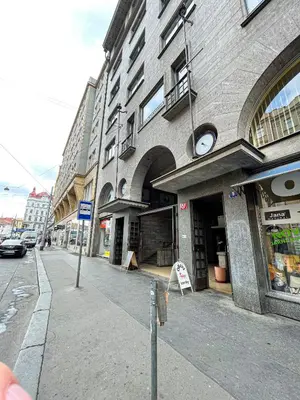 a building with a clock on the side of a street at Vantisch Studio in Prague