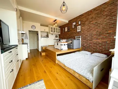 a bedroom with a brick wall and a bed at Vantisch Studio in Prague