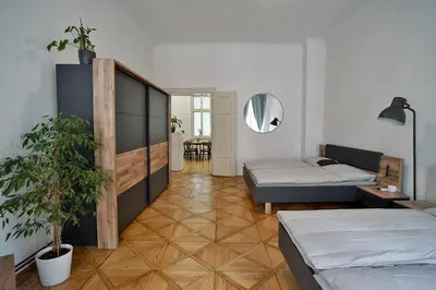 a bedroom with two beds and a mirror at TRUHLÁŘSKÁ 4 APARTMENT in Prague