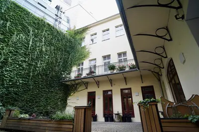 a ivy covered building with a bench next to a building at TRUHLÁŘSKÁ 4 APARTMENT in Prague