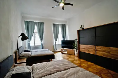 a bedroom with two beds and a ceiling fan at TRUHLÁŘSKÁ 4 APARTMENT in Prague