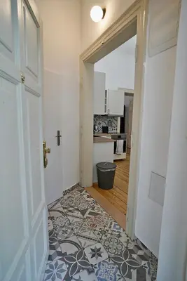 a hallway with an open door to a kitchen at TRUHLÁŘSKÁ 4 APARTMENT in Prague