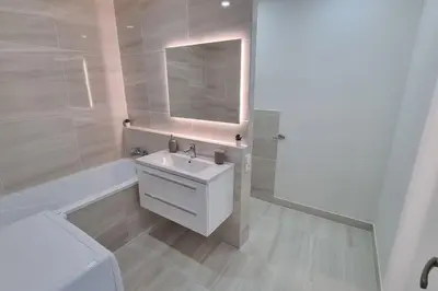 a white bathroom with a sink and a mirror at Finnem Rentals Varnsdorfská in Prague