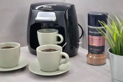 two cups of coffee on a counter next to a coffee maker at Finnem Rentals Varnsdorfská in Prague
