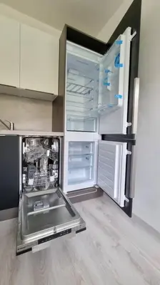 an empty refrigerator with its door open in a kitchen at Finnem Rentals Varnsdorfská in Prague