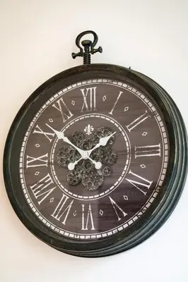 a clock with roman numerals is hanging on a wall at Emperors Elegance Suite in Prague
