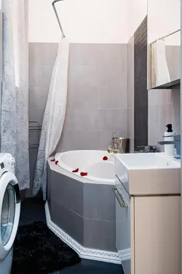 a bathroom with a tub and a sink and a toilet at Emperors Elegance Suite in Prague