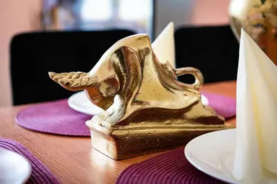 a gold shoe on top of a table at Emperors Elegance Suite in Prague