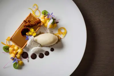 a plate of food with chocolate and flowers on it at Emperors Elegance Suite in Prague