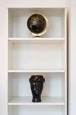 a shelf with a vase and a bowl on it at Emperors Elegance Suite in Prague