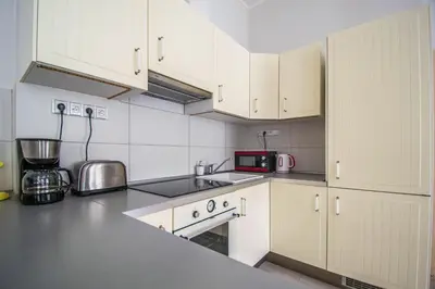 a kitchen and living room with a table and chairs at Ruterra Apartment Charles Bridge in Prague