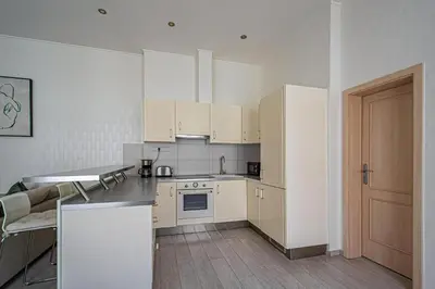 a kitchen with white cabinets and a counter top at Ruterra Apartment Charles Bridge in Prague