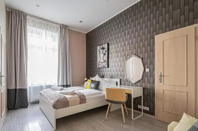 a living room with a white table and green walls at Ruterra Apartment Charles Bridge in Prague