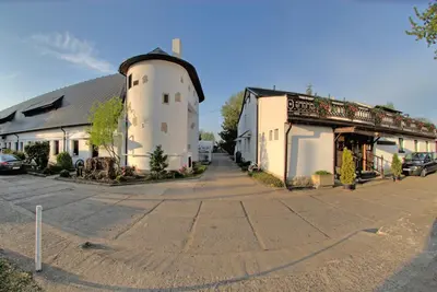 a building with a silo in the middle of a street at Hotel Koliba in Litoměřice
