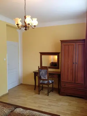 a dining room with a table and a mirror at Hotel Koliba in Litoměřice