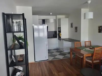 a kitchen and dining room with a table and a refrigerator at New apartment in Karlín, Praha 8, close to center in Prague