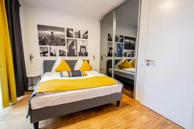 a bedroom with a bed and a mirror at Modern Apartment With Balcony and Garage in Prague